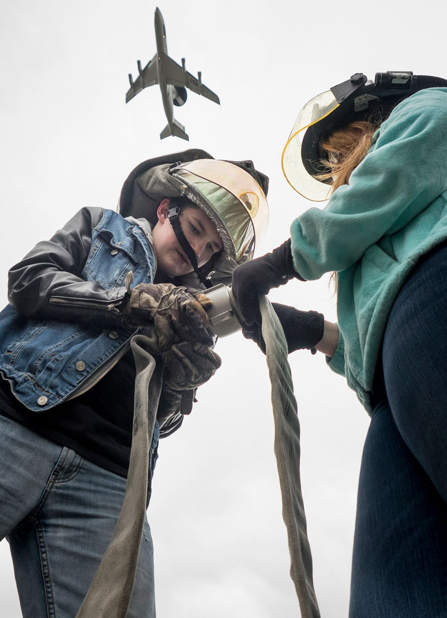 Caleb Hjertquist, a sophomore, left, and Carrie Nordlof, a junior in the Eagle River High School JROTC program, joiin two fire hoses during a firefighting demo challenge hosted by JBER firefighters Sept. 25. (U.S. Air Force photo/Justin Connaher)