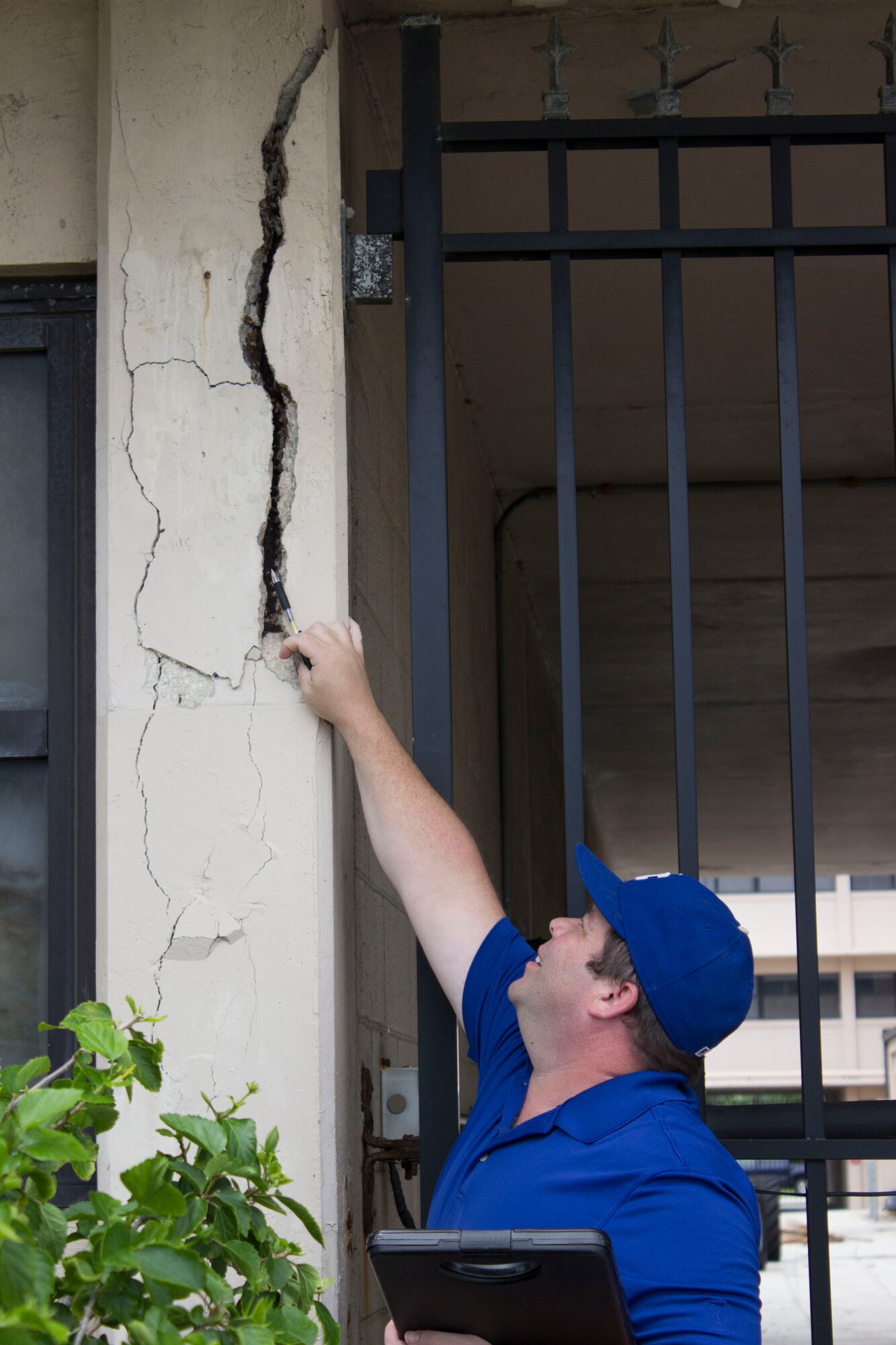 James Widmer, civil engineer for the asset visibility team at the Air Force Civil Engineer Center, investigates how severe the rebar, or reinforcing steel, is corroded in a cracked column at Patrick Air Force Base, Florida. (U.S. Air Force Photo/Susan Lawson/Released)