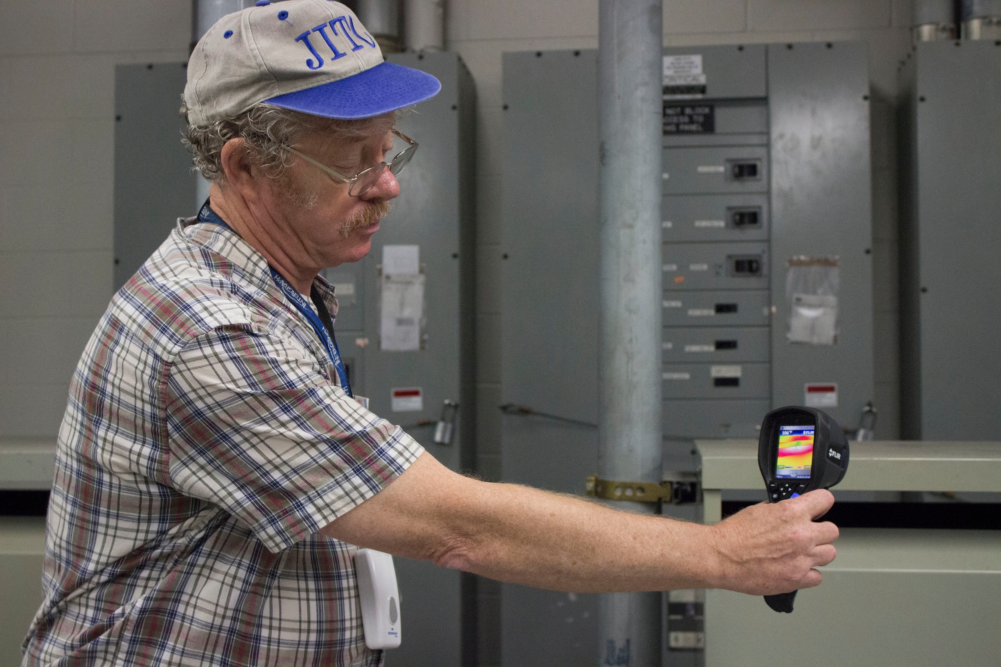 John Turner, professional engineer at the Air Force Civil Engineer Center, reads hot spots on electrical transformer equipment with a thermal camera at Cape Canaveral Air Force Station, Florida. (U.S. Air Force Photo/Susan Lawson/Released)