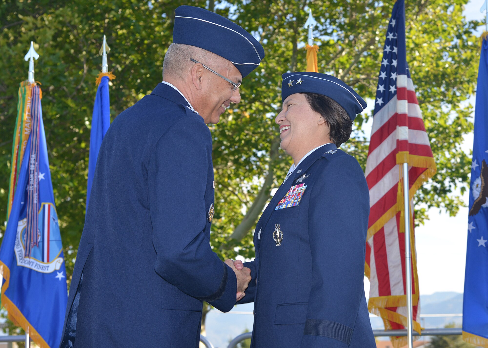 Maj. Gens. Jack Weinstein, 20th Air Force commander, and Sandra Finan, Air Force Nuclear Weapon Center commander, shake hands Oct. 1, 2015, on Kirtland Air Force Base, N.M., during a ceremony transferring administrative control of the 377th Air Base Wing from the AFNWC to the 20th AF. The consolidation of the 377th along with the three AF ICBM wings into 20th AF is specifically intended to help streamline the nuclear enterprise by placing operational mission support within the AF’s nuclear major command.  (U.S. Air Force photo by Todd Berenger)