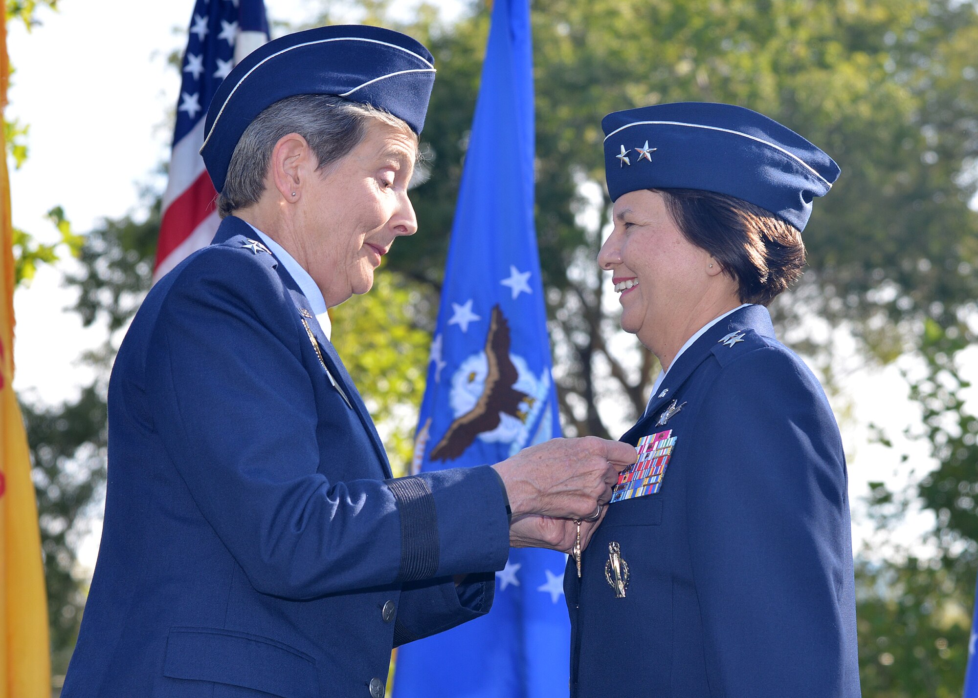 Gen. Ellen Pawlikowski, left, Air Force Materiel Command commander, pins the Air Force Distinguished Service Medal on Maj. Gen. Sandra Finan, former Air Force Nuclear Weapons Center commander, during a change of command ceremony Oct. 1 at Hardin Field.  (Photo by Todd Berenger)