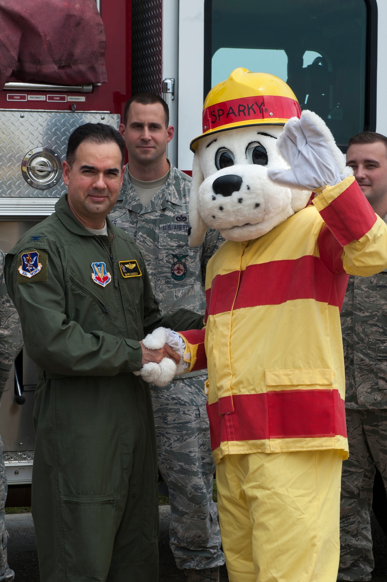 U.S. Air Force Col. Mark Barrera, 23d Wing vice commander, poses for a photo with Sparky the Dog after signing the Fire Prevention Week Proclamation Sept. 21, 2015, at Moody Air Force Base, Ga. The 23d Civil Engineer Squadron Fire Department is slated to host FPW Oct. 4 through Oct. 10 to raise awareness on base and in the community about the importance of smoke detectors and fire safety. (U.S. Air Force photo by Airman 1st Class Kathleen D. Bryant/Released)

