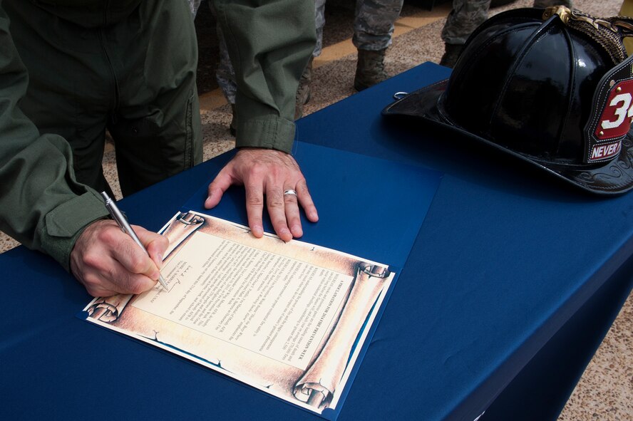 U.S. Air Force Col. Mark Barrera, 23d Wing vice commander, signs the Fire Prevention Week Proclamation Sept. 21, 2015, at Moody Air Force Base, Ga. Barrera called upon all Moody personnel to participate in fire prevention activities at home, work and school to ensure fire safety on base and in the local community. (U.S. Air Force photo by Airman 1st Class Kathleen D. Bryant/Released)

