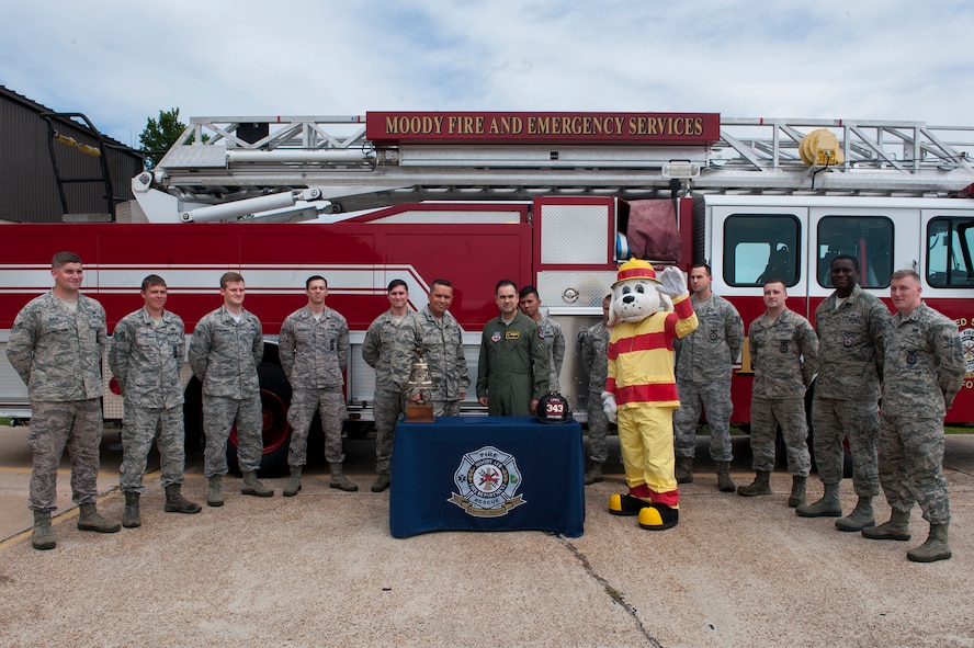 U.S. Air Force Col. Mark Barrera, 23d Wing vice commander, poses with Airmen from the 23d Civil Engineer Squadron Fire Department after signing the Fire Prevention Week Proclamation Sept. 21, 2015, at Moody Air Force Base, Ga. The theme for this year’s Fire Prevention Week, “Hear the Beep Where You Sleep, Every Bedroom Needs a Working Smoke Alarm,” emphasizes the importance of fire safety practices. (U.S. Air Force photo by Airman 1st Class Kathleen D. Bryant/Released)
