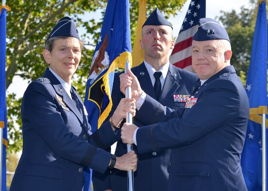 Maj. Gen. Scott Jansson, right, takes the Air Force Nuclear Weapons Center guidon from Gen. Ellen Pawlikowski, Air Force Materiel Command, during a change of command ceremony Oct. 1 at Hardin Field. Jansson is the new AFNWC commander. (Photo by Todd Berenger)