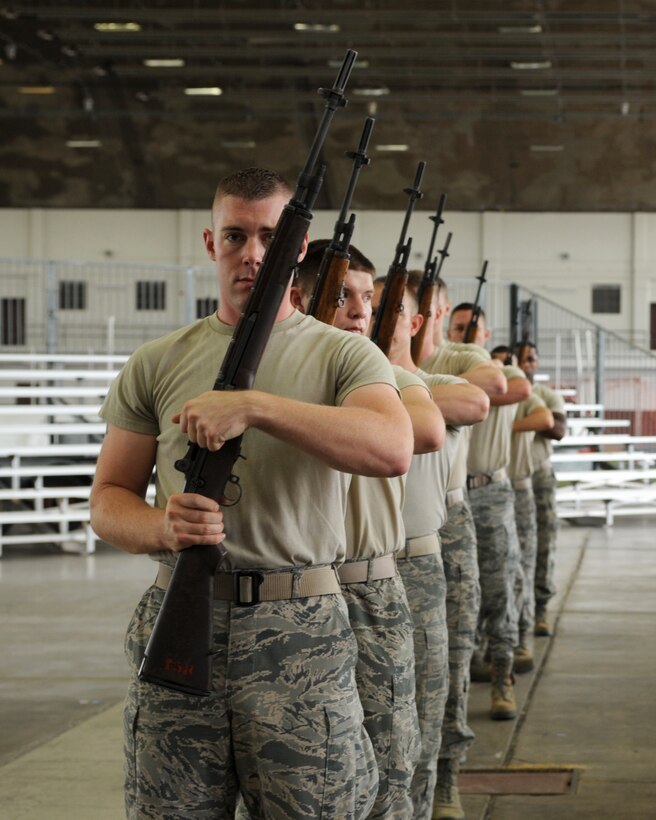 Members of the Ellsworth Honor Guard practice rifle drill during an Honor Guard training session at Ellsworth Air Force Base, S.D., Sept. 23, 2015. The mission of the elite group of Airmen who make up the Ellsworth Honor Guard is to act as representatives for Airmen to both the American public and the world. (U.S. Air Force photo by Airman 1st Class Denise M. Nevins/Released)