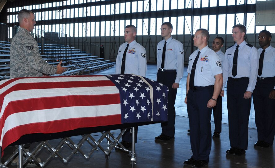 Staff Sgt. Bobby Pantfoeder, Ellsworth Honor Guard NCO in charge, instructs Airmen on how to properly perform the pall bearing formation during Honor Guard training at Ellsworth Air Force Base, S.D., Sept. 21, 2015. The Ellsworth Honor Guard is responsible for providing military honors throughout a 114,636 square-mile area including South Dakota, western Nebraska and northern Wyoming. (U.S. Air Force photo by Airman 1st Class Denise M. Nevins/Released)