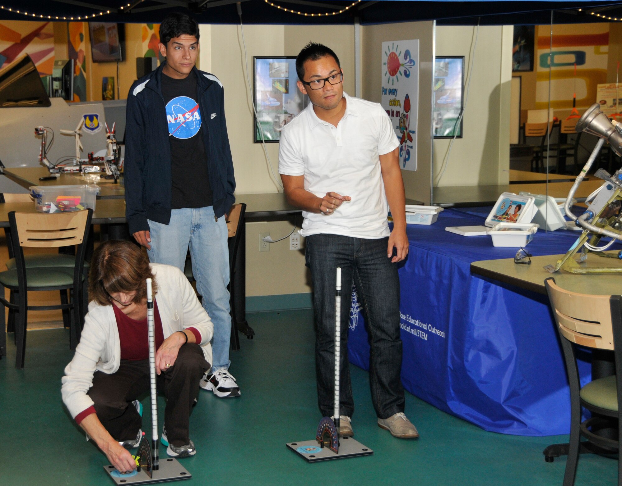 Barbara Birdsong, Stefan Lindorfer and Jack Ly learn how to use hands-on learning equipment available at the AEDC STEM center. Here they try out the rocket launchers that schools can use as part of their STEM learning programs. 