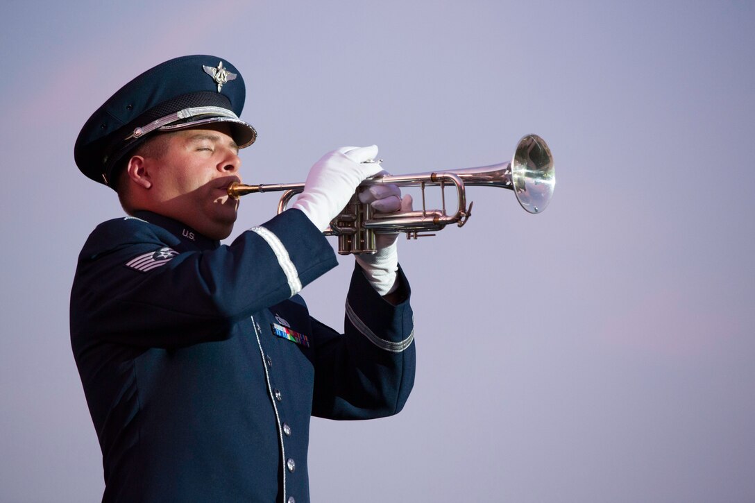 Technical Sgt. Michael Brest performs bugle calls and taps during the USAF Tattoo, September 16, 2015. The Air Force Distrct of Washington commemorated the U.S. Air Force's 68th birthday with this official ceremony on September 17 with a celebration of music, drill and ceremony, aircraft, and fireworks on the Air Force Ceremonial Lawn at Joint Base Anacostia-Bolling. (Courtesy photo by Lt. Cmdr. Jim Remington/released).