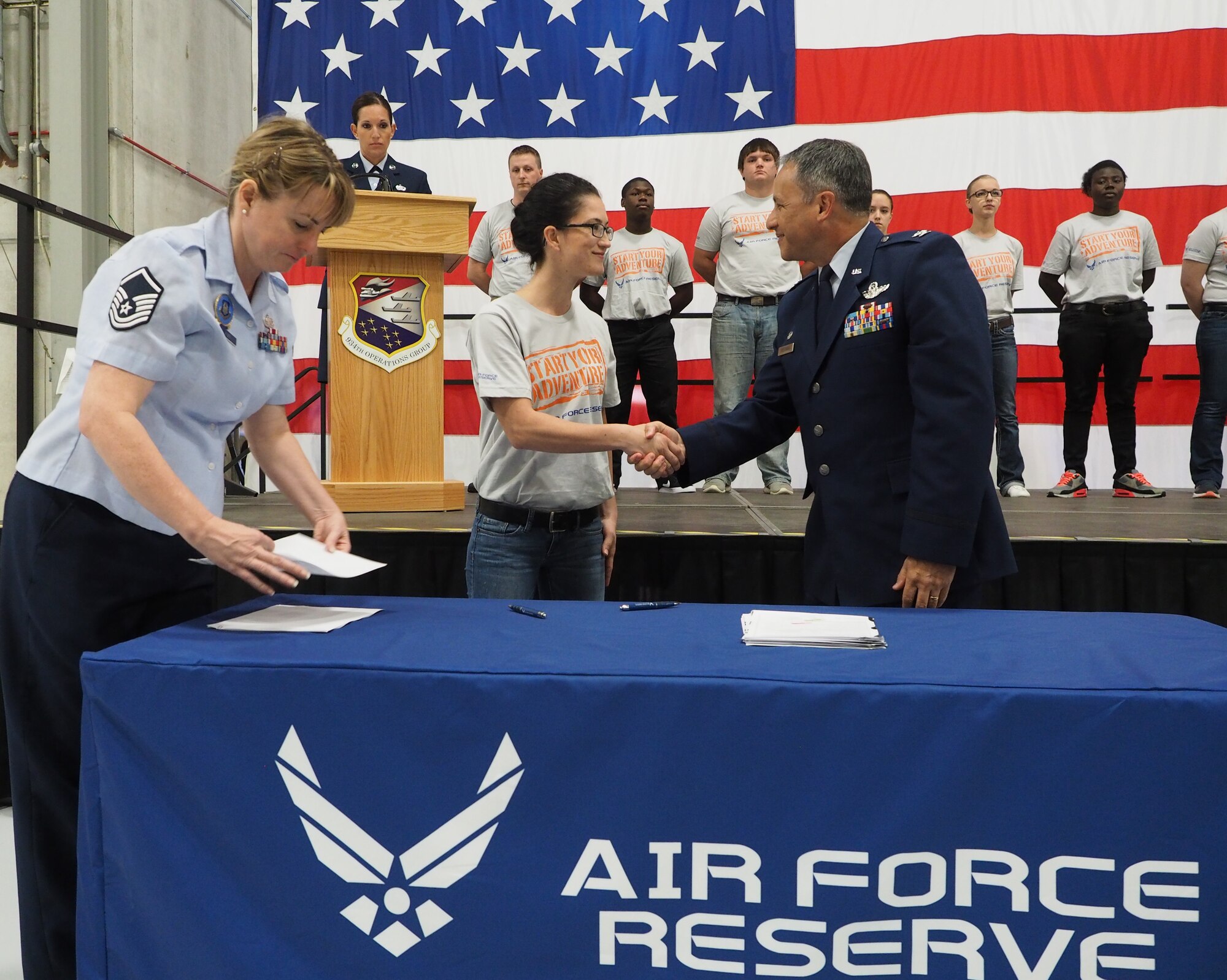 Trainee Angelica Blain receives congratulations from Col. Todd J. McCubbin, 934th Airlift Wing commander, after enlisting in the Air Force Reserve Oct. 1. Blain will return to the 934th as an Air Force Reservist after completing Basic Military Training where she will work in the Aeromedical Evacuation Squadron. (Air Force Photo by Paul Zadach/Released)

