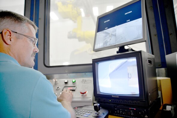 Jeffrey Jacobs, 402nd CMXG machinist, operates the Plastic Media Blast Robot. The new
process provides semi-automated robotic de-paint capabilities for F-15 stabilizers and C-130 long flap skins. (U.S. Air Force photo by Ed Aspera)