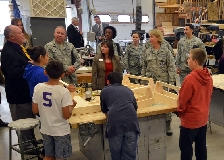 Mark McPherson, Ellicott High School principal, discusses the school’s wood-working vocational program to Col. DeAnna M. Burt, 50th Space Wing commander, and other Schriever leadership during a tour of the Ellicott School District in Ellicott, Colorado, Wednesday, Sept. 30, 2015. The wood-working projects made by the students will be featured and sold in the district’s November craft show. (U.S. Air Force photo/Staff Sgt. Debbie Lockhart)