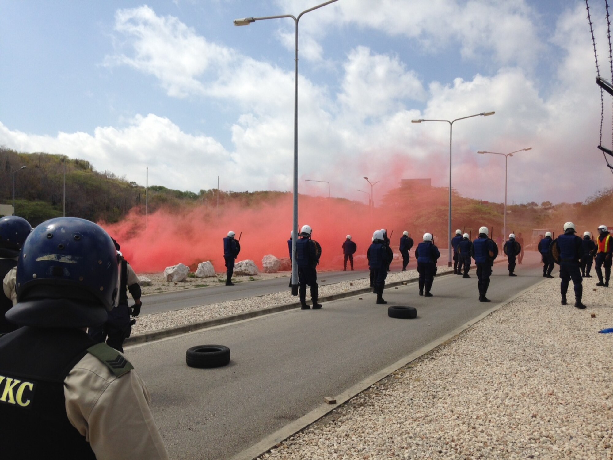 Members of the U.S. Forward Operation Location Curacao, Korps Police Curacao and the Vrijwilligers Korps Curacao, participated in a Joint Confrontation Management Riot Exercise at the U.S. Forward Operation Location Curacao, Sept. 27, 2015.  This exercise brought three law enforcement agencies together in an effort to forge strong partnerships in protecting assets at the FOL and within the community.  The training exercise was approximately three hours long and resulted in successful joint riot exercise training for all parties involved.  This was the first exercise where all three agencies collaborated and worked together as a team to achieve all the training objectives.  All the agencies considered the exercise to be successful in preparing themselves for any type of future riot control measures that may occur. (Courtesy photo/Released) 