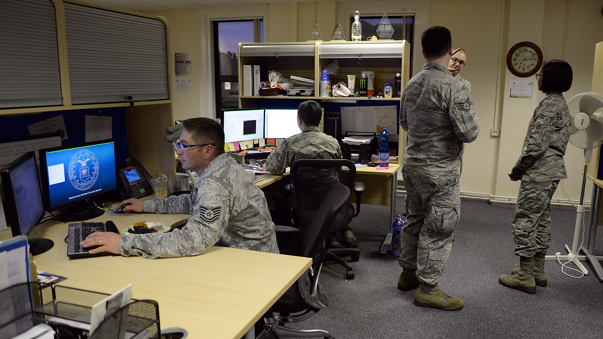 U.S. Air Force Airmen from the 100th Comptroller Squadron work diligently Sept. 30, 2015 on RAF Mildenhall, England. The 100th CPTS financial services team scanned through approximately 3,000 overseas housing allowance documents as part of a Secretary of the Air Force - directed audit. Airmen went through documents – each of which takes about 10 minutes to pull up and examine – for any utilities that may be included, but should not be in OHA. (U.S. Air Force photo by Senior Airman Christine Halan/Released)