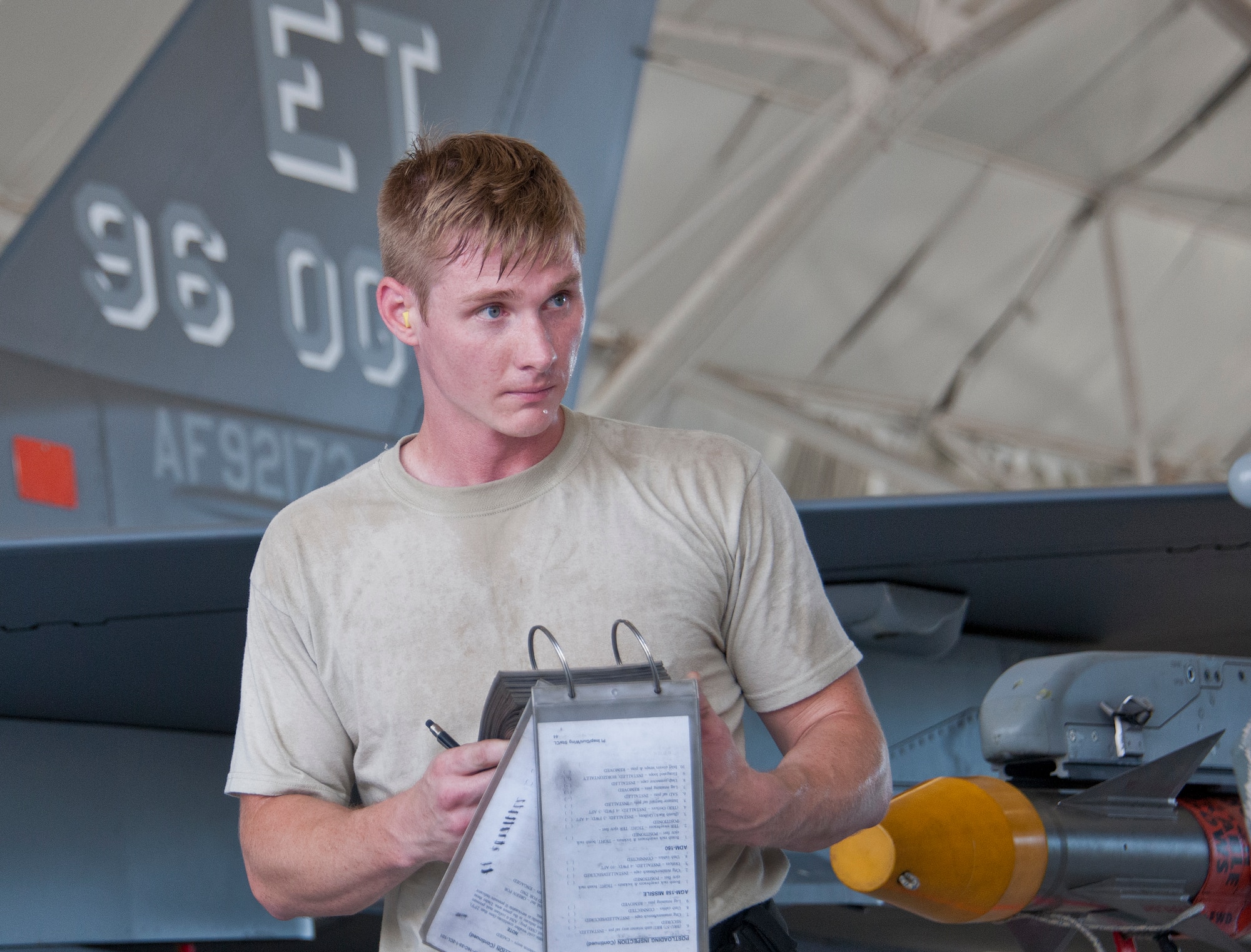 Staff Sgt. Robert Biederman, 96th Aircraft Maintenance Squadron Blue, reviews his F-16 Fighting Falcon maintenance checklist during the third quarter loadcrew competition Sept. 30 at Eglin Air Force Base, Fla.  The AMU-Red F-15 team won the competition, loading three missiles in the quickest time with the fewest discrepancies.  (U. S. Air Force photo/Samuel King Jr.)