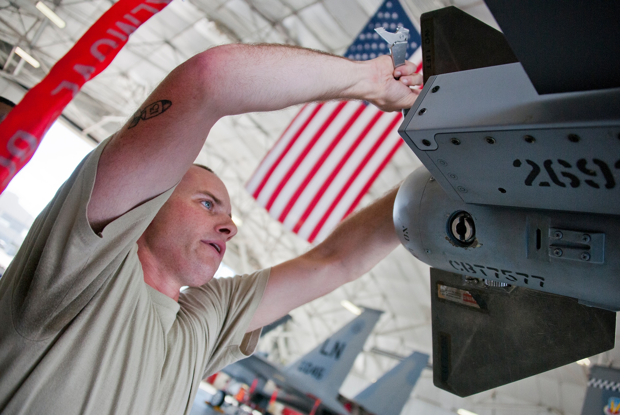 Senior Airman Jonathan Atstupenas, 96th Aircraft Maintenance Squadron Blue, secures the missile is in place on an F-16 Fighting Falcon during the third quarter loadcrew competition Sept. 30 at Eglin Air Force Base, Fla.  The AMU-Red F-15 team won the competition, loading three missiles in the quickest time with the fewest discrepancies.  (U. S. Air Force photo/Samuel King Jr.)