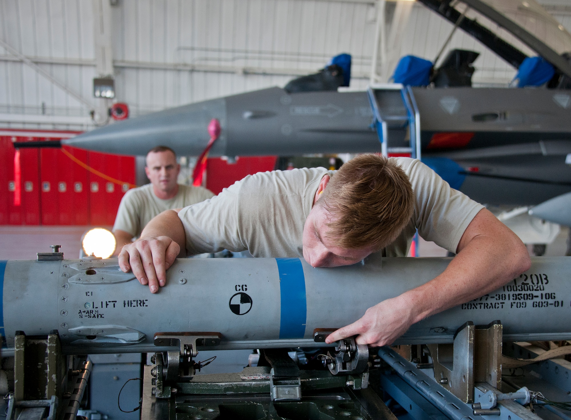 Staff Sgt. Robert Biederman, 96th Aircraft Maintenance Squadron Blue, checks the missile position before giving the order to move it toward a F-16 Fighting Falcon during the third quarter loadcrew competition Sept. 30 at Eglin Air Force Base, Fla.  The AMU-Red F-15 team won the competition, loading three missiles in the quickest time with the fewest discrepancies.  (U. S. Air Force photo/Samuel King Jr.)