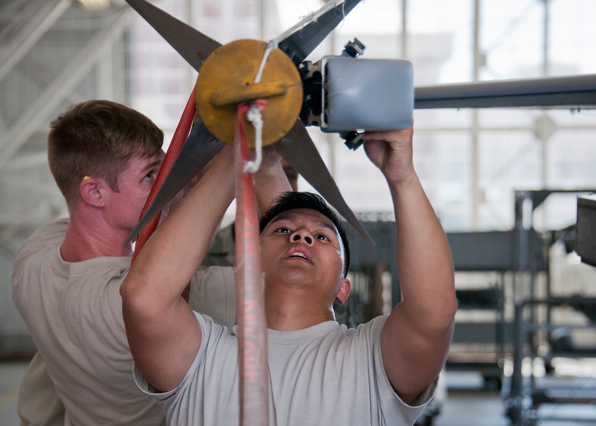 Senior Airman Frederick Guaren and Staff Sgt. Robert Biederman, 96th Aircraft Maintenance Squadron Blue, load a missile onto their F-16 Fighting Falcon during the third quarter loadcrew competition Sept. 30 at Eglin Air Force Base, Fla.  The AMU-Red F-15 Eagle team won the competition, loading three missiles in the quickest time with the fewest discrepancies.  (U. S. Air Force photo/Samuel King Jr.)