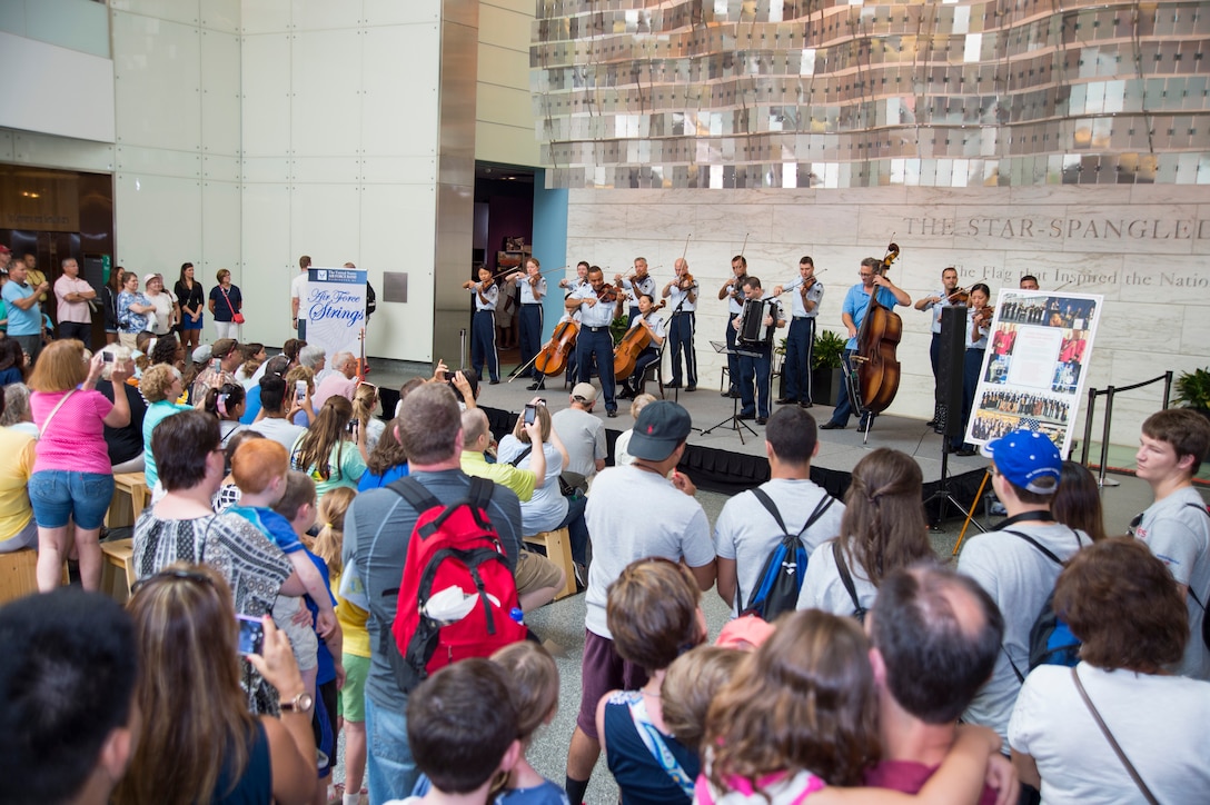 An audience gathers to listen to the U.S. Air Force Band's Strolling Strings at the National Museum of American Histroy in Washginton, D.C., July 16, 2015. The Strolling Strings performance was part of the museum's Star-Spangled American Music Series. (U.S. Air Force photo/Airman 1st Class Ryan J. Sonnier).