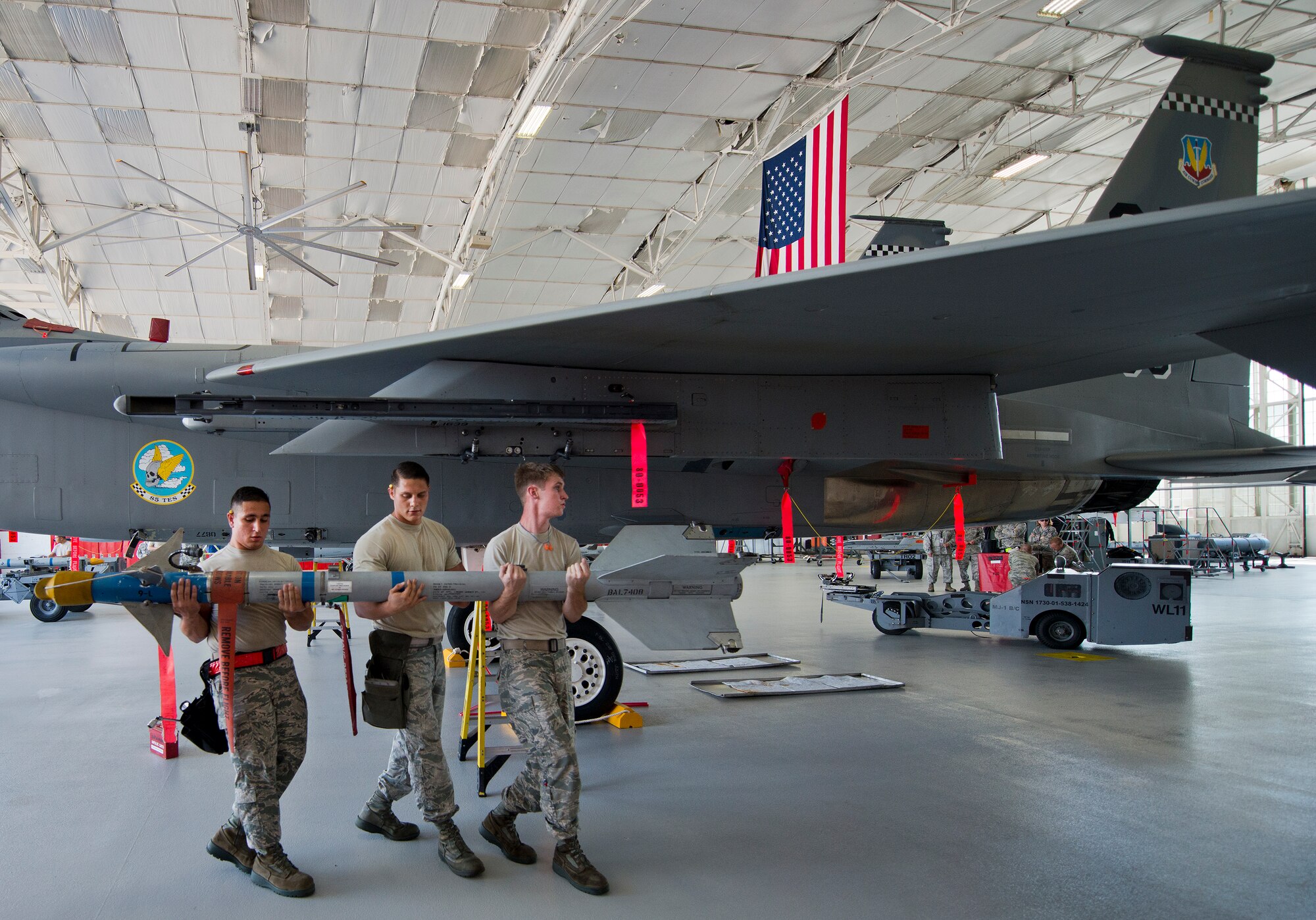 The 96th Aircraft Maintenance Squadron Red team moves a missile toward their F-15 Eagle during the third quarter loadcrew competition Sept. 30 at Eglin Air Force Base, Fla.  The Red team won the competition loading three missiles in the quickest time with the fewest discrepancies.  (U. S. Air Force photo/Samuel King Jr.)