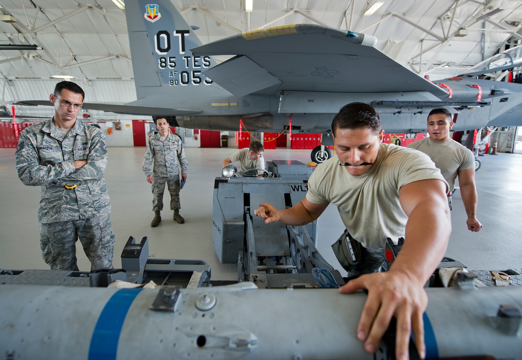 Staff Sgt. Vincent Franco, 96th Aircraft Maintenance Squadron Red, gives the order to move a missile during the third quarter loadcrew competition Sept. 30 at Eglin Air Force Base, Fla.  The Red team won the competition loading three missiles onto their F-15 Eagle in the quickest time with the fewest discrepancies.  (U. S. Air Force photo/Samuel King Jr.)