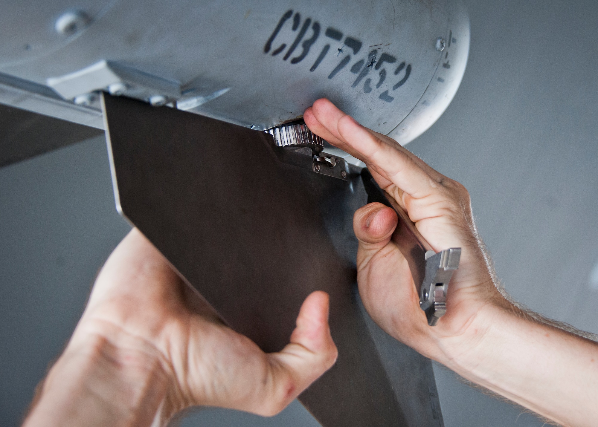 A 96th Aircraft Maintenance Squadron Red team member tightens down a fin onto a missile during the third quarter loadcrew competition Sept. 30 at Eglin Air Force Base, Fla.  The Red team won the competition loading three missiles onto their F-15 Eagle in the quickest time with the fewest discrepancies.  (U. S. Air Force photo/Samuel King Jr.)