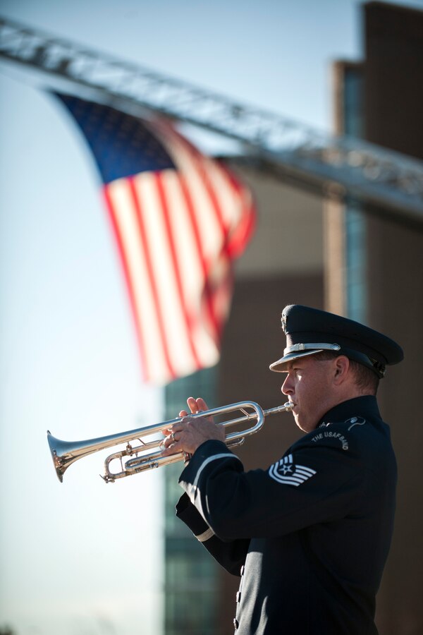 Technical Sgt. Matthew Misener plays Taps during a Patriot's Day Reveille Ceremony at Heritage Park, Joint Base Andrews, Md., Sept. 11, 2015. The ceremony paid tribute to the first responders and victims of the terrorist attacks on Sept. 11, 2001. (U.S. Air Force photo by Airman 1st Class Philip Bryant/released) 
