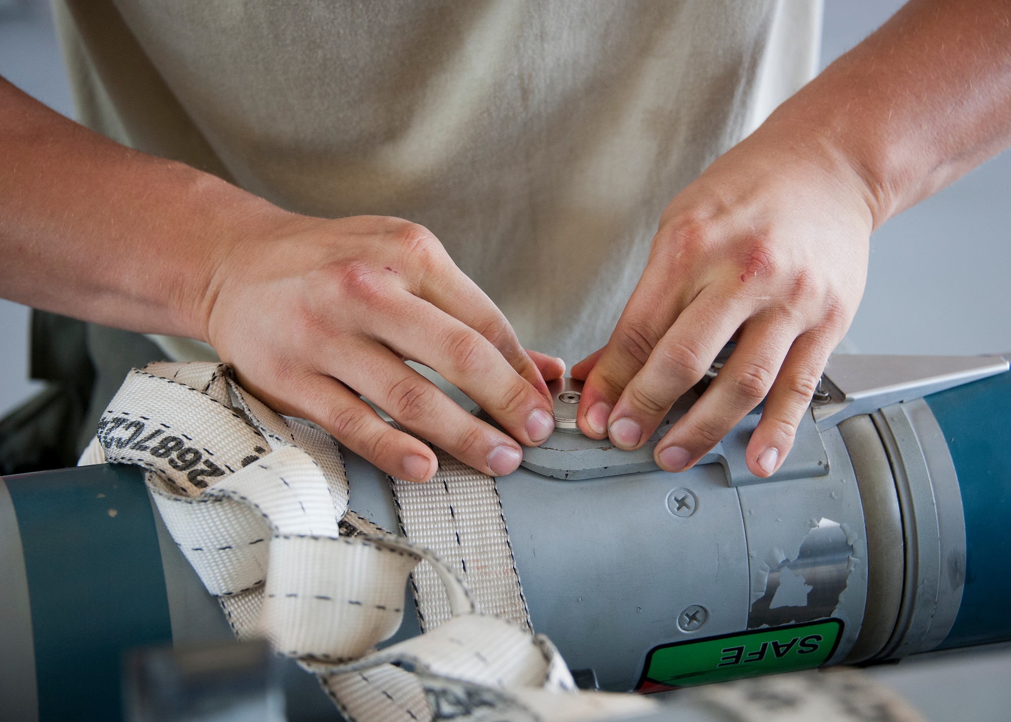 Staff Sgt. Vincent Franco, 96th Aircraft Maintenance Squadron Red, loosens the mid-body connector cap during the third quarter loadcrew competition Sept. 30 at Eglin Air Force Base, Fla.  The Red team won the competition loading three missiles onto their F-15 Eagle in the quickest time with the fewest discrepancies.  (U. S. Air Force photo/Samuel King Jr.)