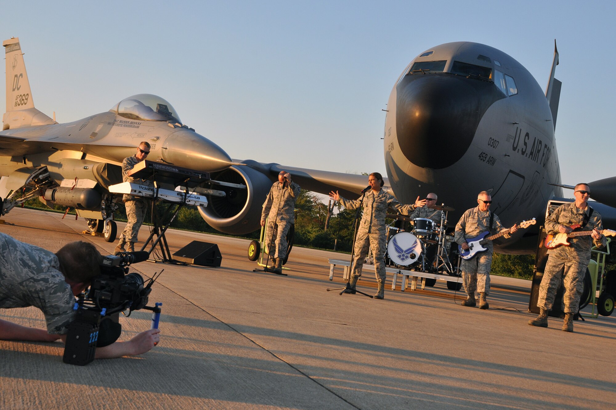 Technical Sgt.
Nick Kibbey, 11th Wing Public Affairs broadcast journalist, captures video
footage of the U.S. Air Force Band Max Impact for a music video on the Joint
Base Andrews flight line Aug. 26, 2015. A 459th Air Refueling Wing KC-135R
Stratotanker and 113th Wing F-16 Fighting Falcon helped set the stage for
the band during the media event. (U.S. Air Force photo/Staff Sgt. Kat Lynn
Justen)
