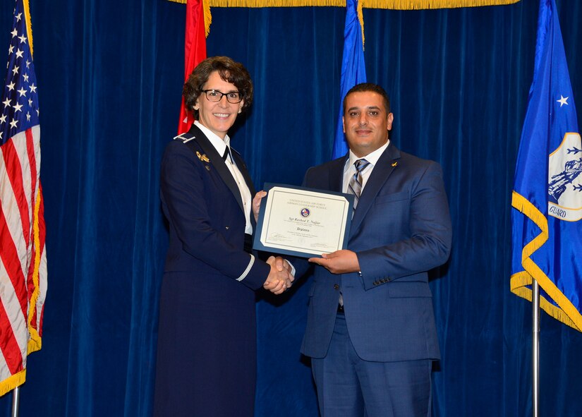 MCGHEE TYSON AIR NATIONAL GUARD BASE, Tenn. - Jordanian Sgt. Rashed T. Najjar receives his diploma from Col. Jessica Meyeraan, commander of the I.G. Brown Training and Education Center, here, Sept. 29, 2015, at the TEC. The TEC often hosts international students in their Airman leadership school and NCO academy as part of the Air Force's international training and education program.(U.S. Air National Guard photo by Master Sgt. Jerry D. Harlan/Released)