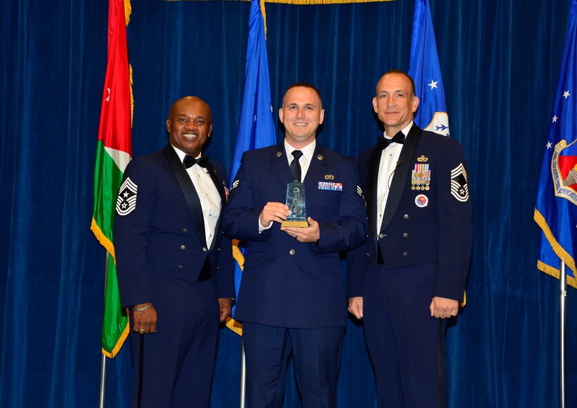 MCGHEE TYSON AIR NATIONAL GUARD BASE, Tenn. -  Senior Airman Michael Garcia, from the New Jersey Air National Guard, receives the Commandant Leadership Award for Airman leadership school class 15-8 from Chief Master Sgt. Anthony Whitehead, command Chief Master Sgt. for the Air National Guard Readiness Center, left, and Chief Master Sgt. Edward L. Walden, Sr., commandant of the Paul H. Lankford Enlisted PME Center, here, Sept. 29, 2015, at the I.G. Brown Training and Education Center(U.S. Air National Guard photo by Master Sgt. Jerry D. Harlan/Released)
