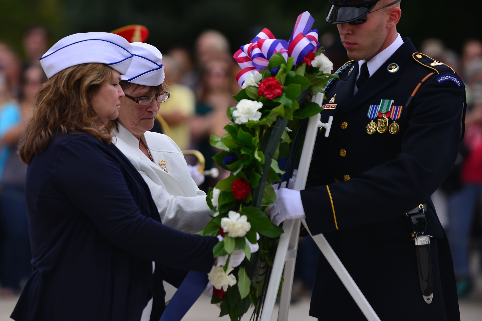 American Blue Star Mothers look over a ceremonial wreath before it is laid in recognition of U.S. Service members who lost their lives, during the Gold Star Mother’s Day Observance at Arlington National Cemetery in Arlington, Va., Sept. 27, 2015. Blue Star Mothers of America, Inc., is a support organization for any female legal guardian of U.S. Service members and veterans. (U.S. Air Force photo by Staff Sgt. Natasha Stannard/Released)