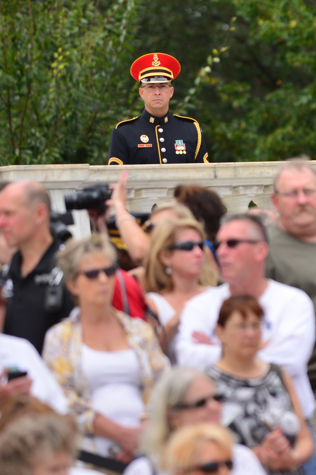 A U.S. service member watches the Gold Star Mother’s Day Observance at Arlington National Cemetery in Arlington, Va., Sept. 27, 2015. The annual nation-wide observance recognizes mothers whose sons or daughters lost their lives serving in the U.S. Armed Forces during a time of war or conflict.  (U.S. Air Force photo by Staff Sgt. Natasha Stannard/Released)