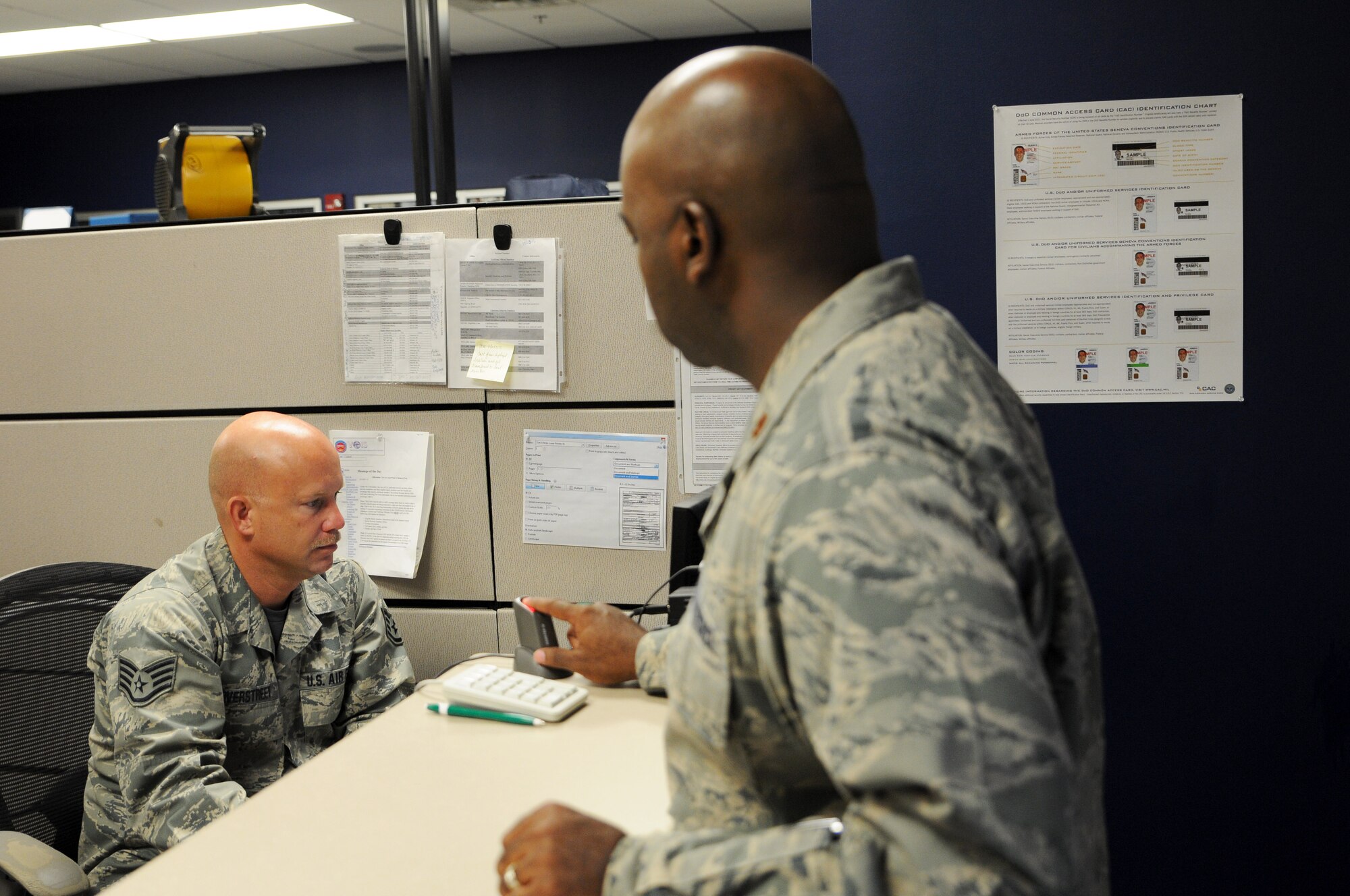 Staff Sgt. Tony Overstreet, 188th Force Support Squadron customer service representative, assists Maj. Lionel Riley Sept. 20, 2015 by troubleshooting his common access card at Ebbing Air National Guard Base, Fort Smith, Ark. Overstreet has been selected for the Oct. 2015 The Flying Razorback spotlight. (U.S. Air National Guard photo by Senior Airman Cody Martin/Released)
