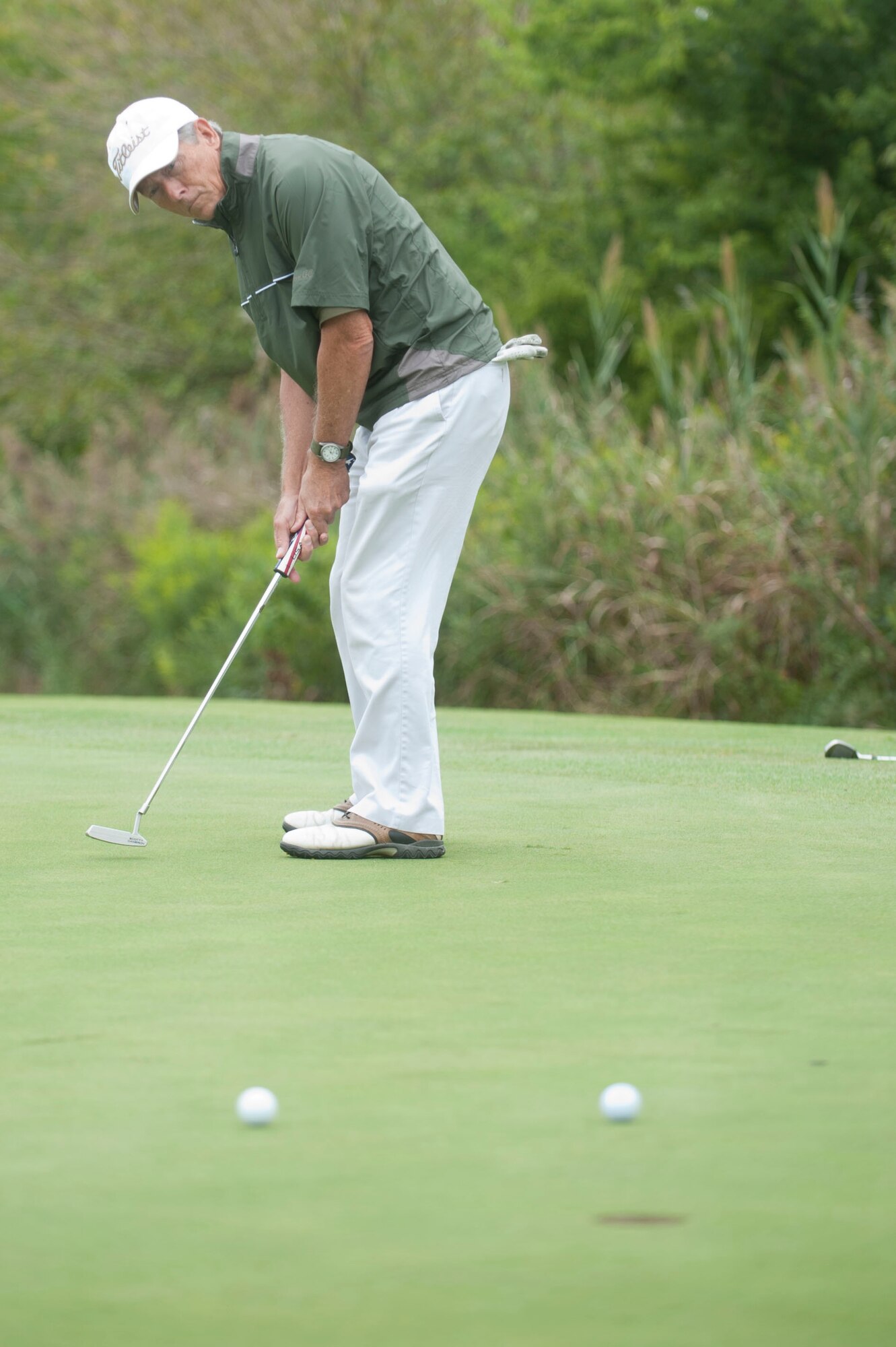 John Hickok, 633rd Force Support Squadron fitness center director, putts a ball during the Commander’s Cup golf tournament at Eaglewood Golf Course at Langley Air Force Base, Va., Sept. 25, 2015. The Raptor course features 18 holes, totaling 6,428 yards of golf from the longest tees and a course par of 72. (U.S. Air Force photo by Senior Airman R. Alex Durbin/Released)