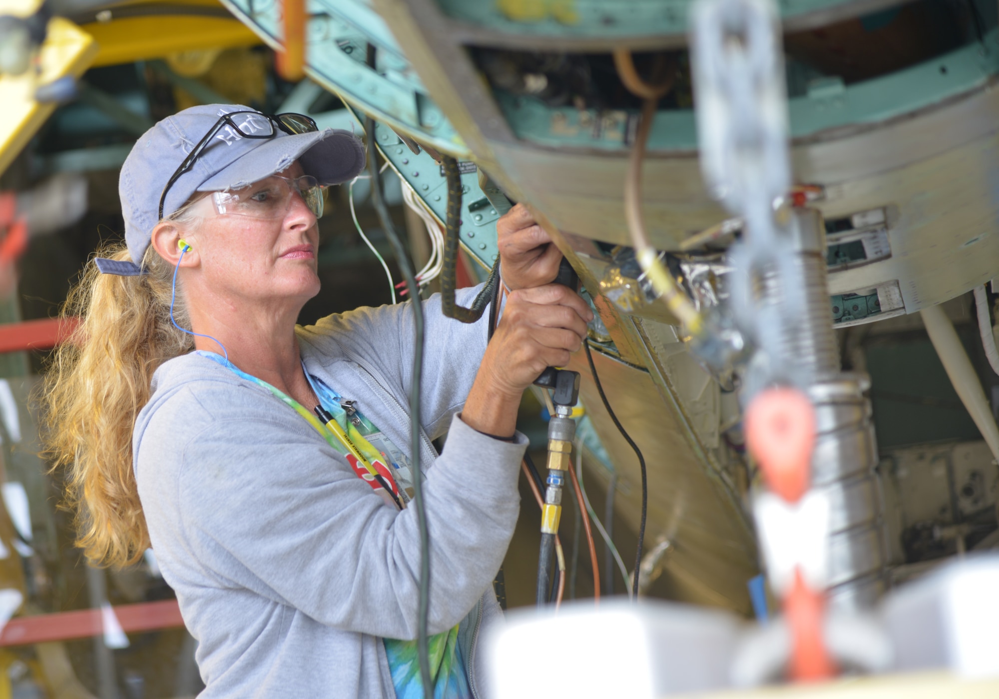 Ingrid Causey, 561st Aircraft Maintenance Squadron Rewire Flight electrician, unmounts jacks on one of the panel doors of the F-15. (U.S. Air Force photo by Ray Crayton)