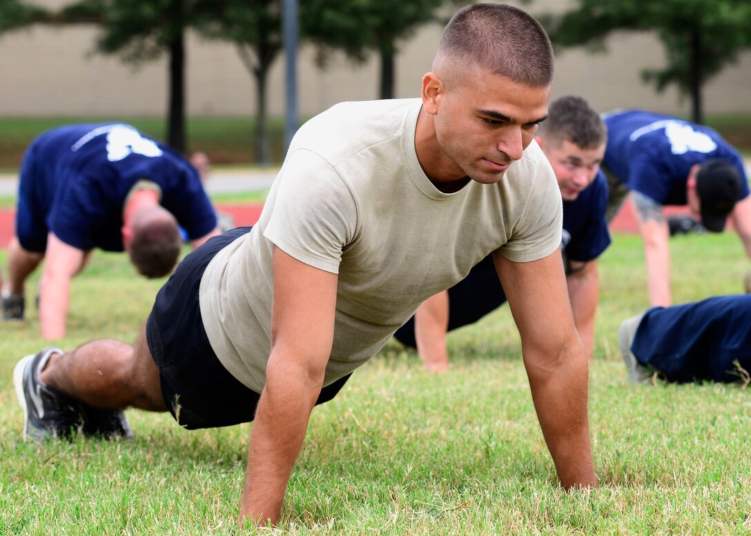 U.S. Air Force Staff Sgt. Michael Svoleantopoulos, 30th Intelligence Squadron surveillance and warning supervisor, performs push-ups during the Air Force Team Cohesion Challenge at Langley Air Force Base, Va., Sept. 25, 2015. This is the first TCC held at Langley AFB, but because of the success more are planned for the future. (U.S. Air Force photo by Airman 1st Class Derek Seifert/ Released)
