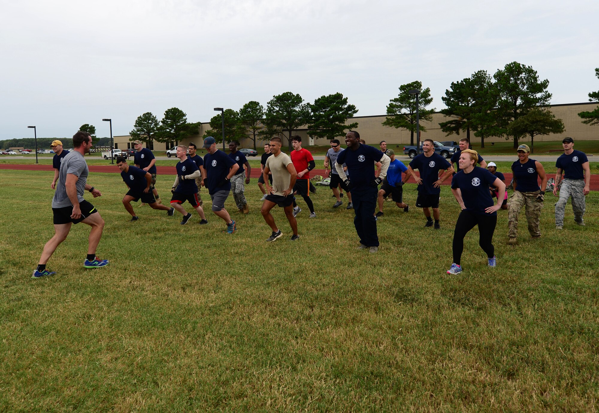 U.S. Air Force Airmen are led by a cadre in lunges during the Air Force Team Cohesion Challenge at Langley Air Force Base, Va., Sept. 25, 2015. TCC events are led by U.S. military special operators.(U.S. Air Force photo by Airman 1st Class Derek Seifert/ Released)