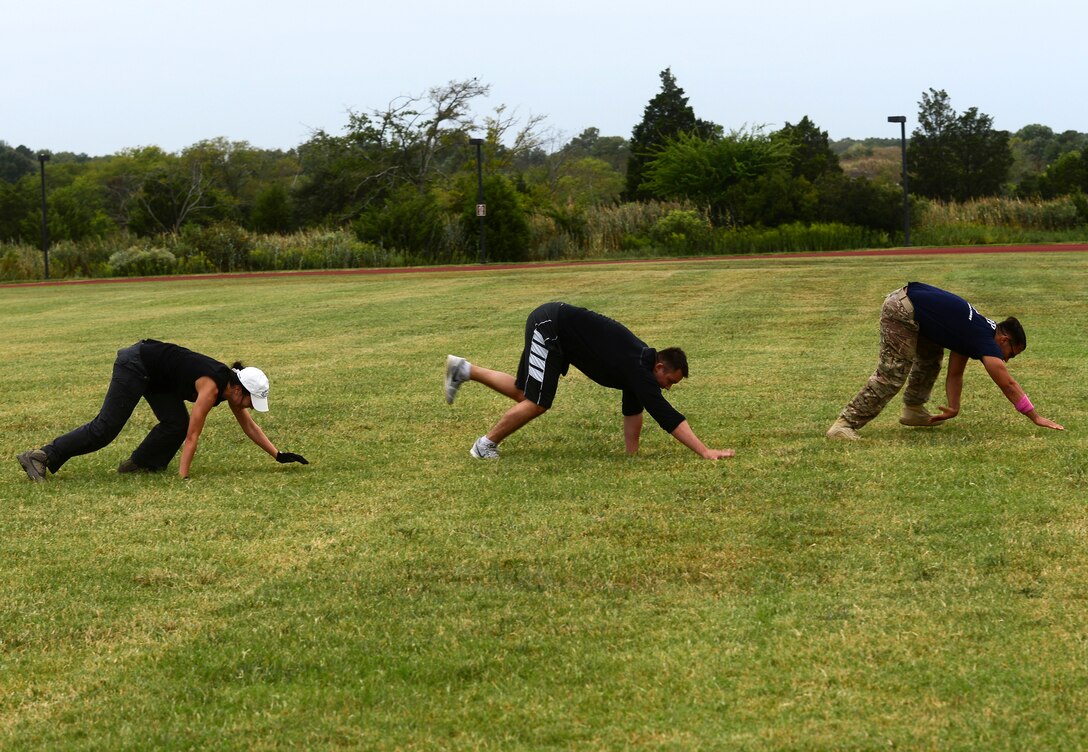 U.S. Air Force Airmen bear crawl after losing a team race during the Air Force Team Cohesion Challenge at Langley Air Force Base, Va., Sept. 25, 2015. During the challenge, Airmen developed their physical, mental, social and spiritual wellness. (U.S. Air Force photo by Airman 1st Class Derek Seifert/ Released) 