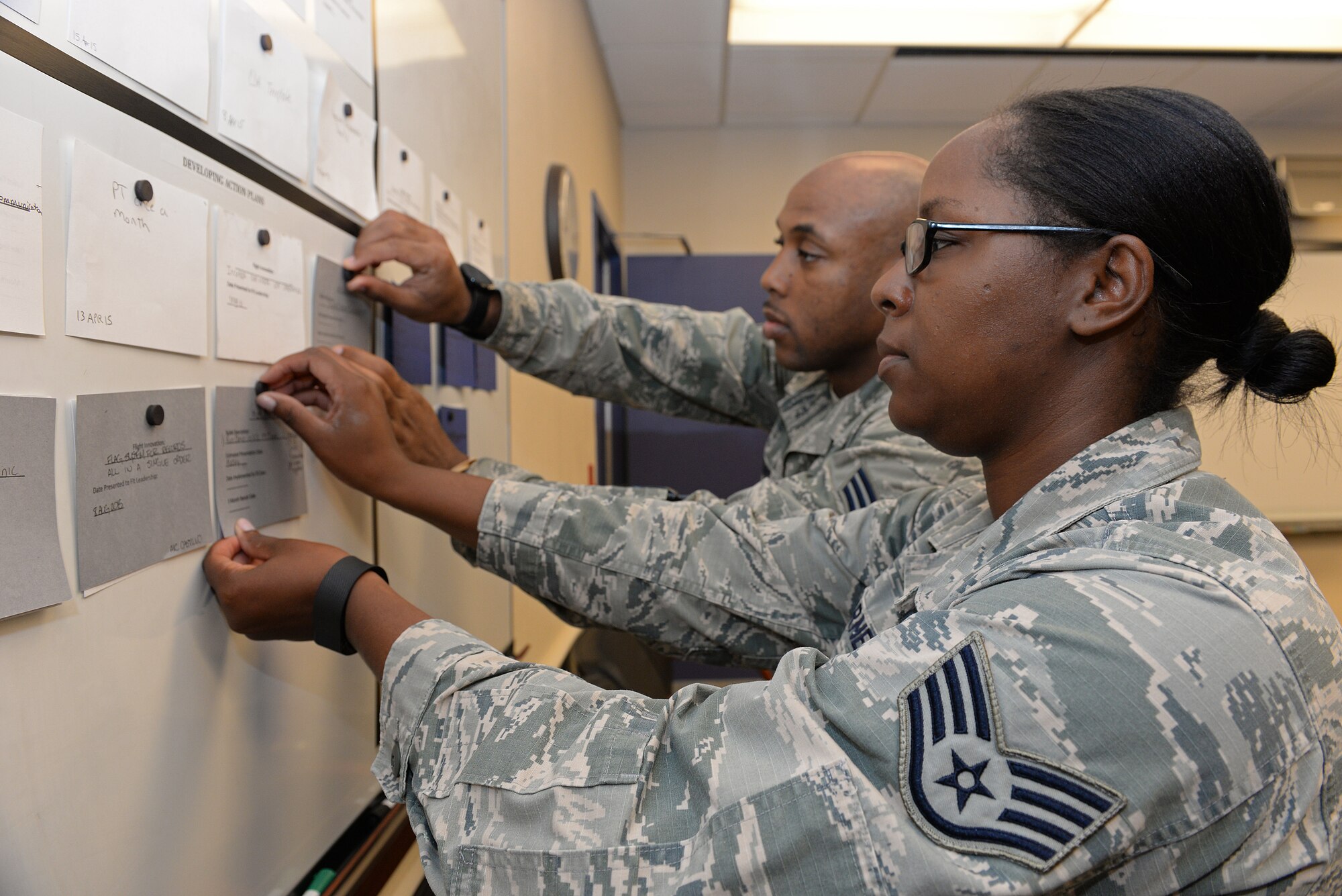 Staff Sgt. Melissa Barnes, 375th Dental Squadron Lab Technician and Senior Airman Antoine McInnis, Dental Assistant, pin ideas on the innovation board in the Dental Clinic, Sept. 22, 2015, Scott Air Force Base, Illinois. The idea utilization tool was implemented in April, and the personnel have brought the clinic to number one in Air Mobility Command for the past six months for their low Class I rate. (U.S. Air Force photo by Airman 1st Class Erica Holbert-Siebert)