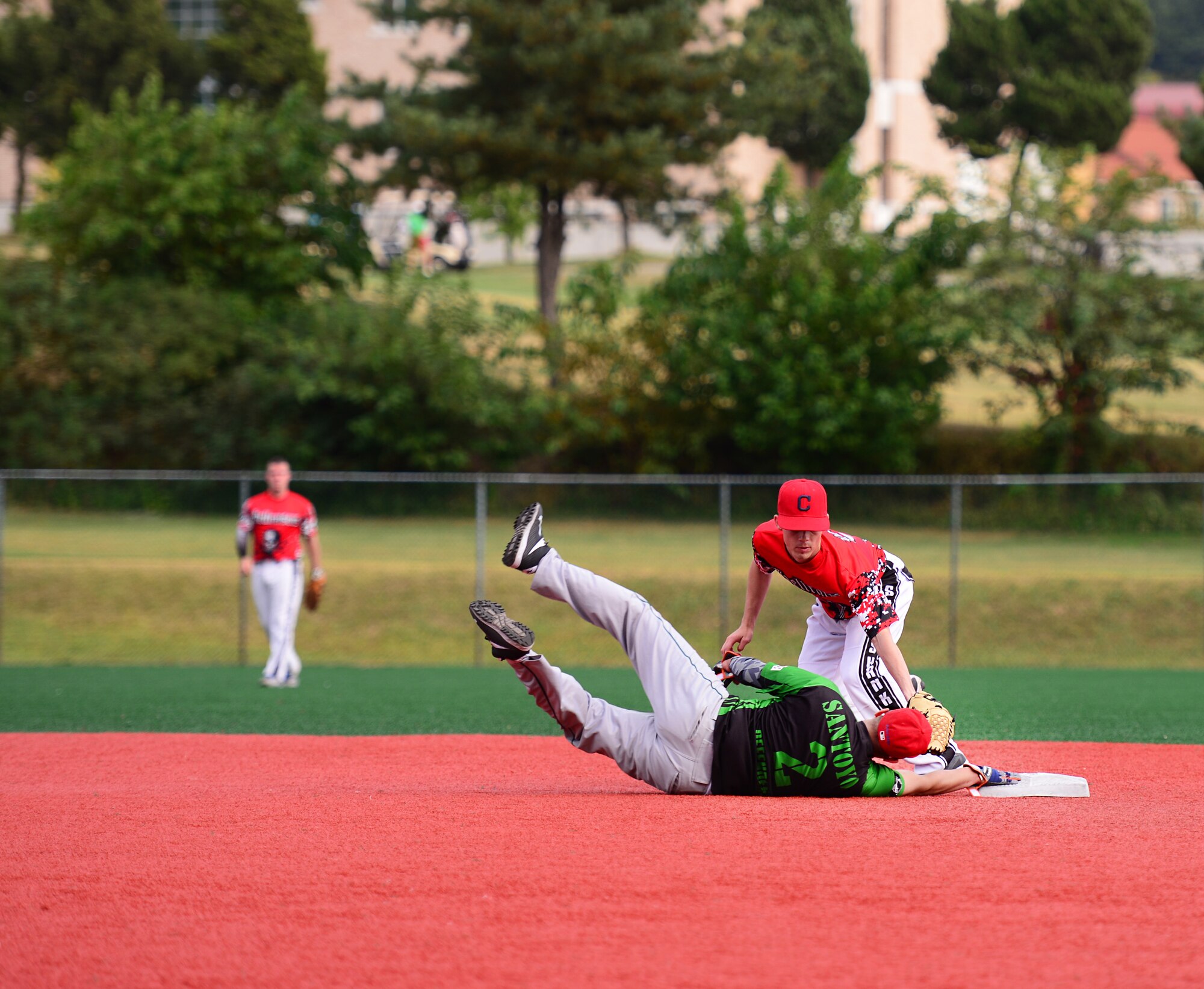 Airman 1st Class Ivan Santoyo, 51st Security Forces Squadron, dives back to second base during a softball game against Soldiers from the 35th Air Defense Artillery Brigade Squadron at Osan Air Base, Republic of Korea, Sept. 29, 2015. Softball was just one of the events Airmen and Soldiers competed in during the second annual Osan Cup.
(U.S. Air Force photo/Staff Sgt. Amber Grimm)