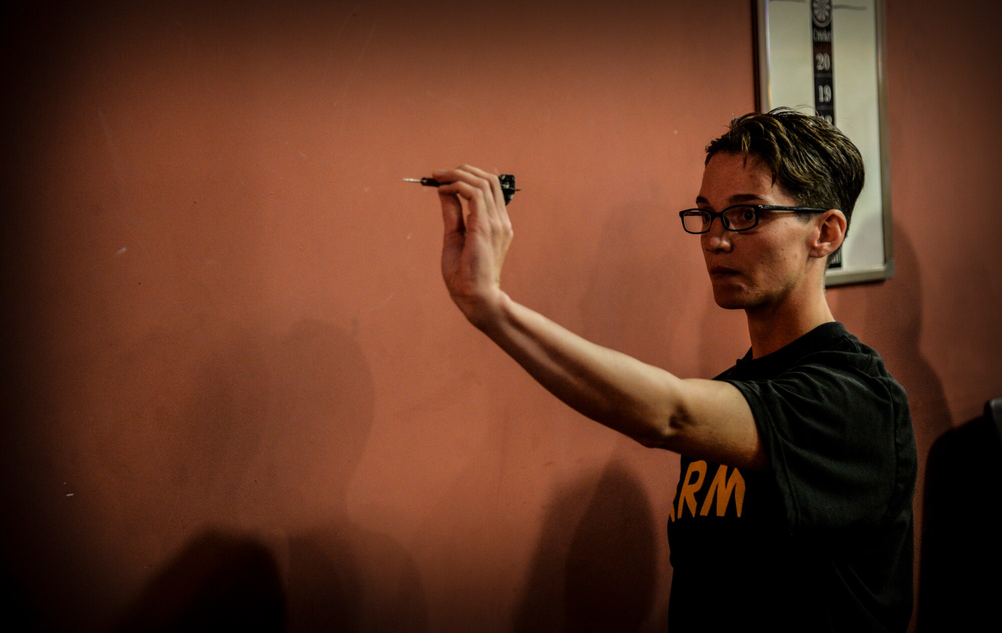 Army Sgt. Alyssa Starnes, 35th Air Defense Artillery Brigade digital training management system manager, takes aim at the dart board at a tournament during the Osan Cup at Osan Air Base, Republic of Korea, Sept. 30, 2015. The Osan cup is a sport-oriented, two-day event that puts squadrons and service members against each other in a battle royal to show who has the most skill, strength and knowledge. (U.S. Air Force photo/Tech. Sgt. Travis Edwards) 