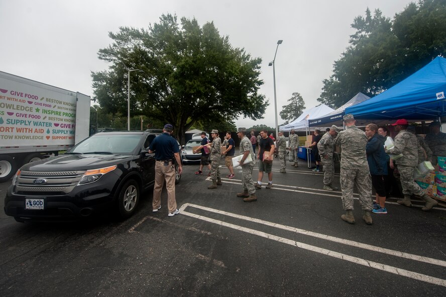 Volunteers from Team Seymour place boxes into cars during the food drive, Sept. 29, 2015, at Seymour Johnson Air Force Base, North Carolina. More than 400 vouchers were given out by the First Sergeants Counsel to Airmen and their families to receive boxes put together by Feed the Children and the USO of North Carolina. (U.S. Air Force photo/Airman Shawna L. Keyes)  