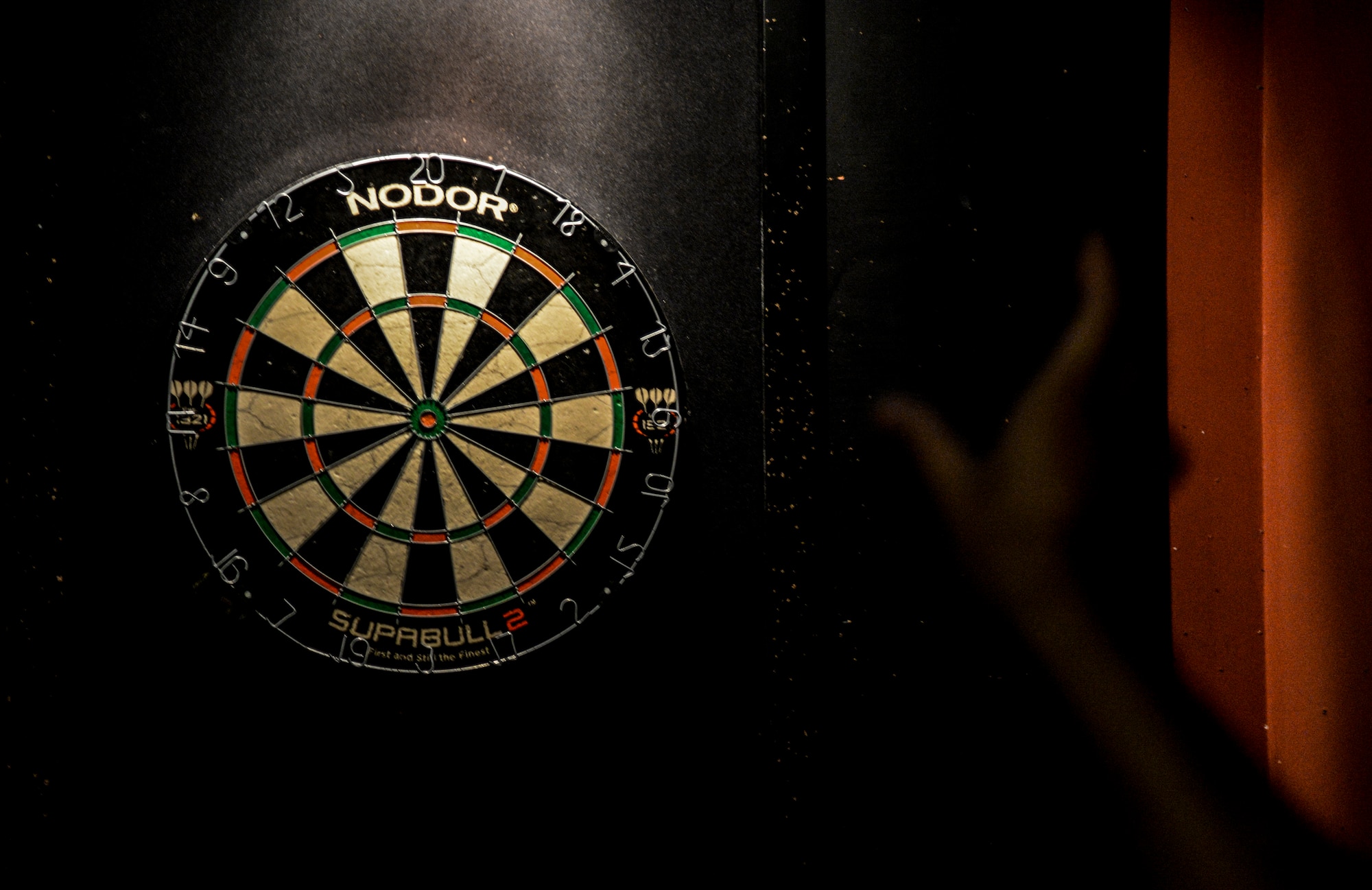 An Airman throws a dart during a dart tournament at the Enlisted Club as part of the Osan Cup at Osan Air Base, Republic of Korea, Sept. 30, 2015. The Osan cup is a sport-oriented, two-day event that puts squadrons and service members against each other in a battle royal to show who has the most skill, strength and knowledge. (U.S. Air Force photo/Tech. Sgt. Travis Edwards) 