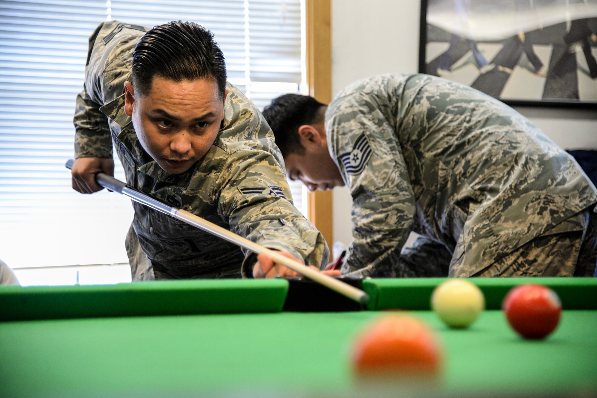 Staff Sgt. Ryan Reyes, 51st Fighter Wing weapons safety manager, takes a shot during the 9-Ball tournament in the Osan Cup at Osan Air Base, Republic of Korea, Sept. 30, 2015. The Osan cup is a sport-oriented, two-day event that puts squadrons and service members against each other in a battle royal to show who has the most skill, strength and knowledge. (U.S. Air Force photo/Tech. Sgt. Travis Edwards) 