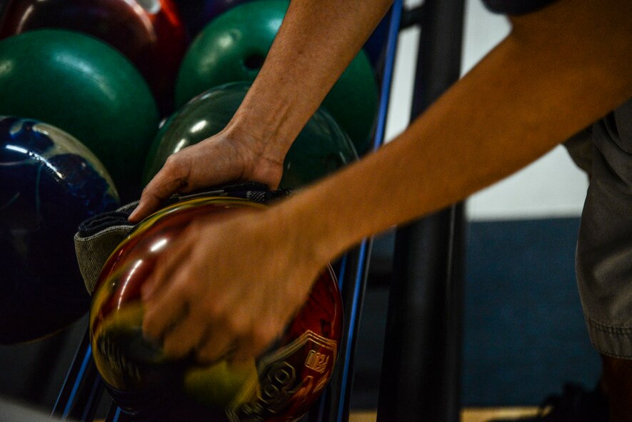 An Airman wipes down his ball before his game begins at the MiG Alleys Bowling Center during the bowling tournament in the Osan Cup at Osan Air Base, Republic of Korea, Sept. 30, 2015. The Osan cup is a sport-oriented, two-day event that puts squadrons and service members against each other in a battle royal to show who has the most skill, strength and knowledge. (U.S. Air Force photo/Tech. Sgt. Travis Edwards) 