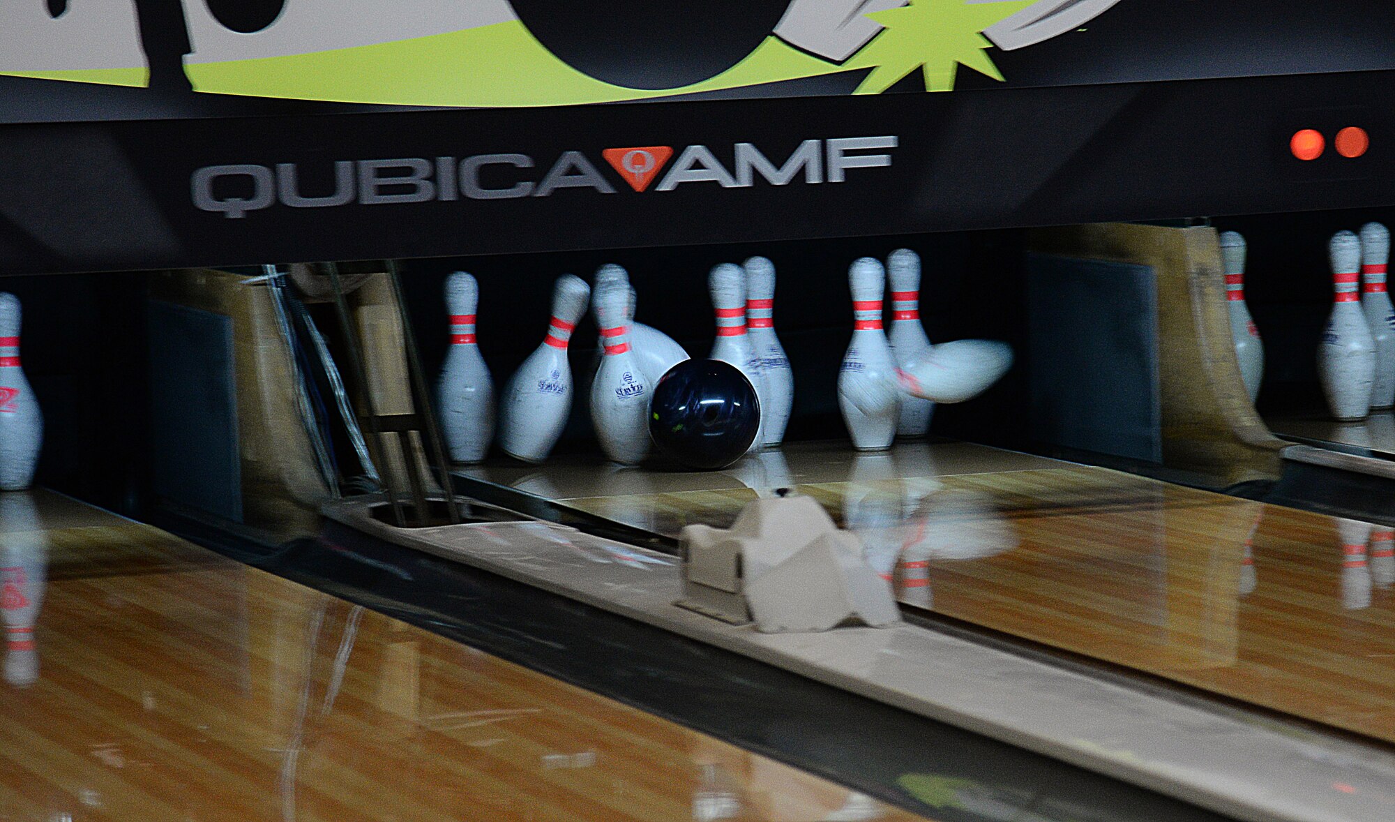A bowling ball slams into a set of pins during a game of bowling at the MiG Alleys Bowling Center during the bowling tournament in the Osan Cup at Osan Air Base, Republic of Korea, Sept. 30, 2015. The Osan cup is a sport-oriented, two-day event that puts squadrons and service members against each other in a battle royal to show who has the most skill, strength and knowledge. (U.S. Air Force photo/Tech. Sgt. Travis Edwards) 