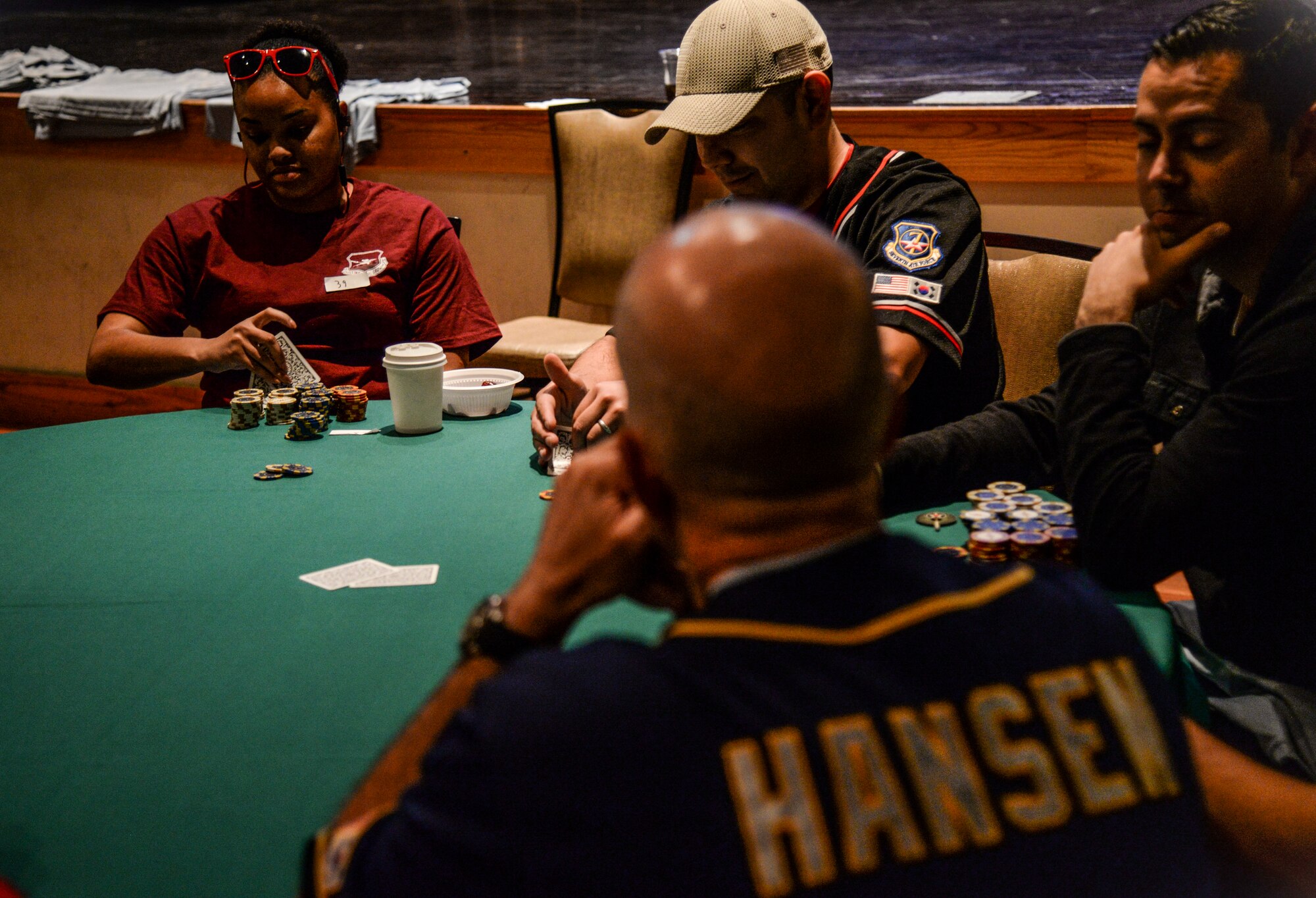Col. Andrew Hansen, 51st Fighter Wing commander waits for his turn during the Texas Hold ’em tournament in the Osan Cup at Osan Air Base, Republic of Korea, Sept. 29, 2015. Out of nearly 130 Airmen and Soldiers, Hansen made it to the final four tables before getting knocked out of the tournament. The Osan cup is a sport-oriented, two-day event that puts squadrons and service members against each other in a battle royal to show who has the most skill, strength and knowledge. (U.S. Air Force photo/Tech. Sgt. Travis Edwards)