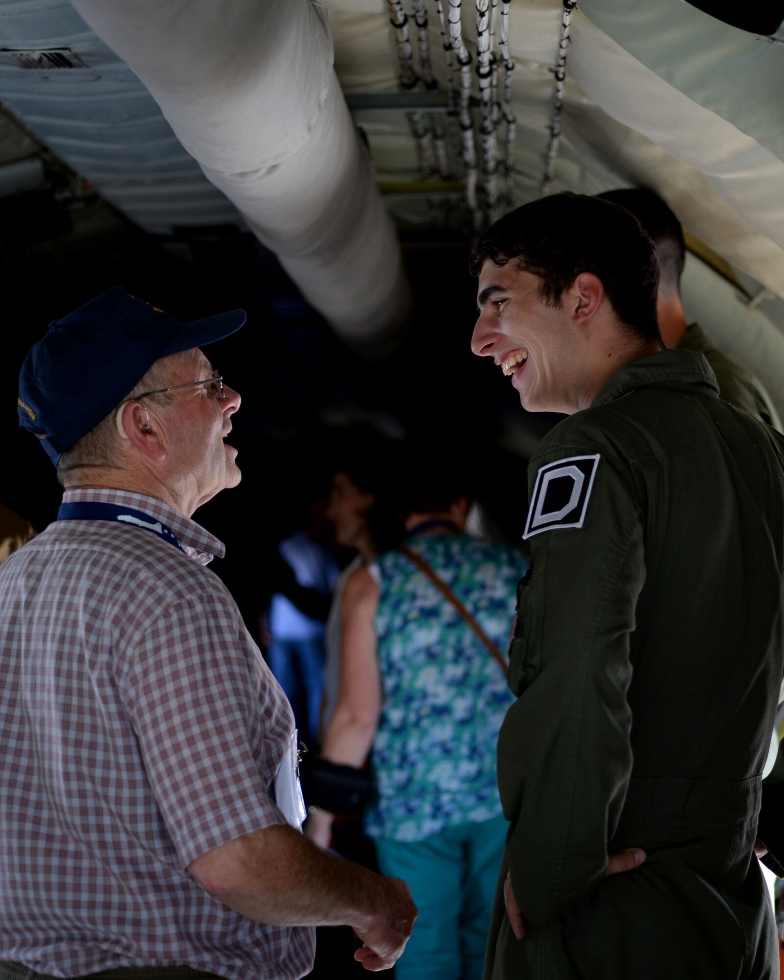 Ron Batley, left, Thorpe Abbotts museum curator, speaks with U.S. Air Force Airman 1st Class Kaleb Bourque, 351st Air Refueling Squadron boom operator, during a static display Sept. 24, 2015, at Louis Armstrong New Orleans International Airport in New Orleans, La. The static display was just one of the visits planned for the 100th Bomb Group Foundation reunion which has been held for more than 40 years. (U.S. Air Force photo by Senior Airman Victoria H. Taylor/Released)