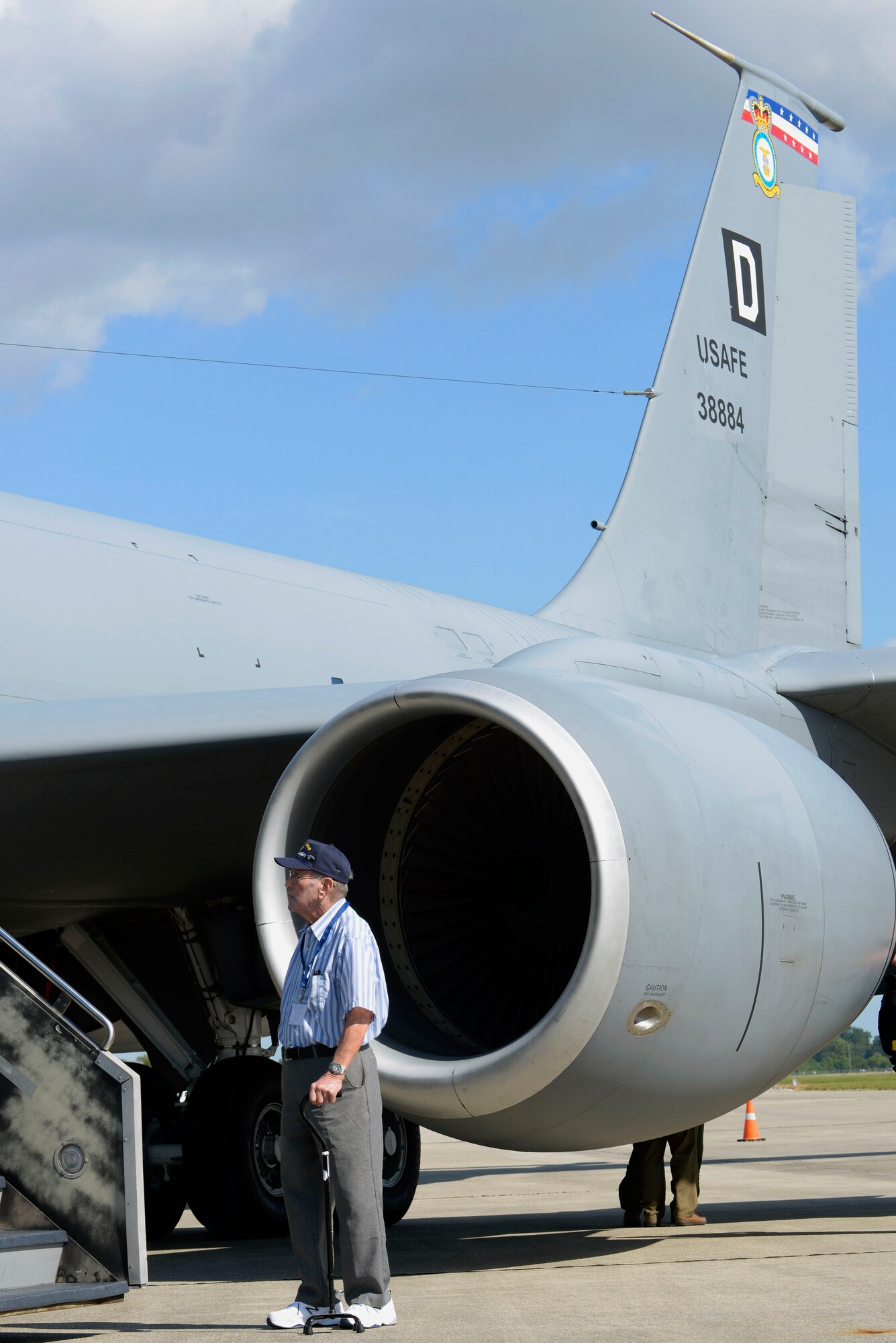 A World War ll veteran stands next to a static display of a KC-135 Stratotanker assigned to RAF Mildenhall Sept. 24, 2015, at Louis Armstrong New Orleans International Airport in New Orleans, La. The Square D located on the tail of the KC-135 became the official designation of the 3rd Air Division and the subordinate 100th BG in 1943. (U.S. Air Force photo by Senior Airman Victoria H. Taylor/Released)
